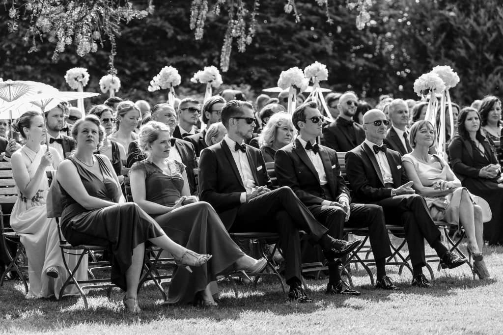 Hochzeit Schloss Gartrop: Die Hochzeitsgäste während der Trauung im Freien