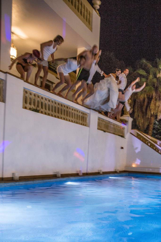 Hochzeit in Barcelona: Brautpaar und Gäste springen während der Hochzeitsparty in den Pool