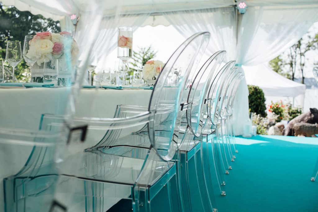 Zelthochzeit mit eleganter Tischdeko und transparenten Plexiglas Stühlen