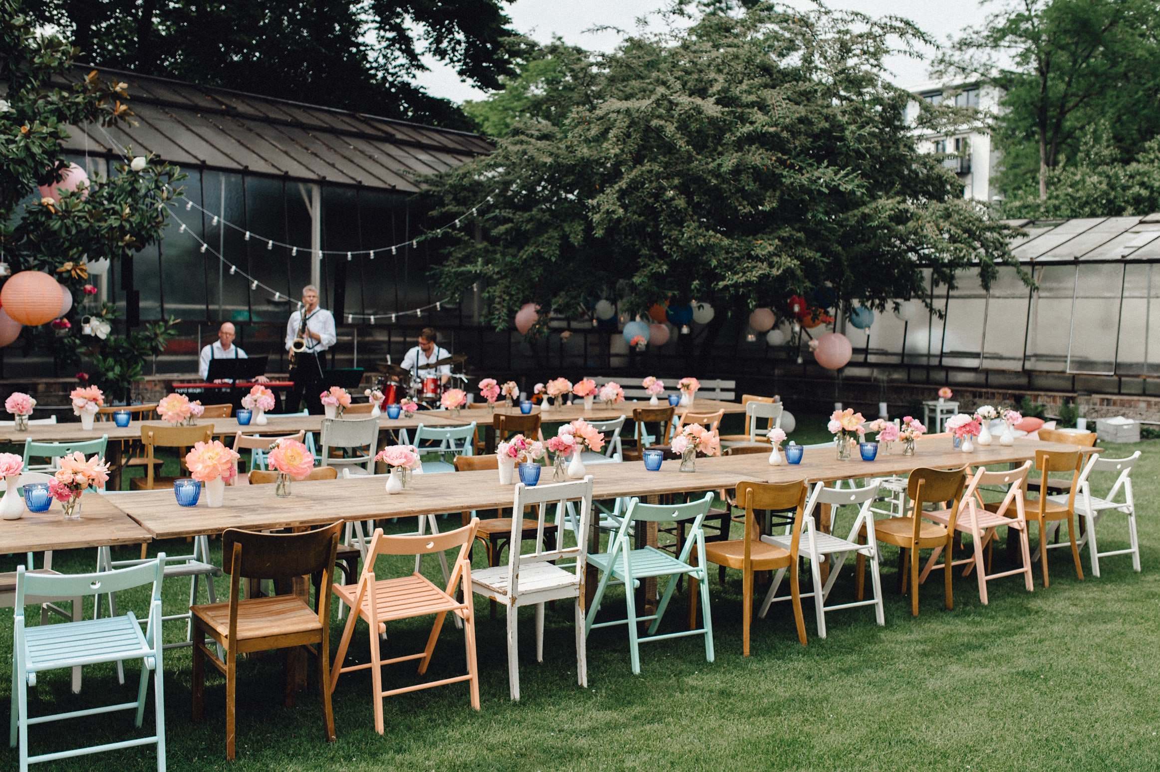 Gartenhochzeit mit rustikalen Holztischen und Mix and Match Stühlen