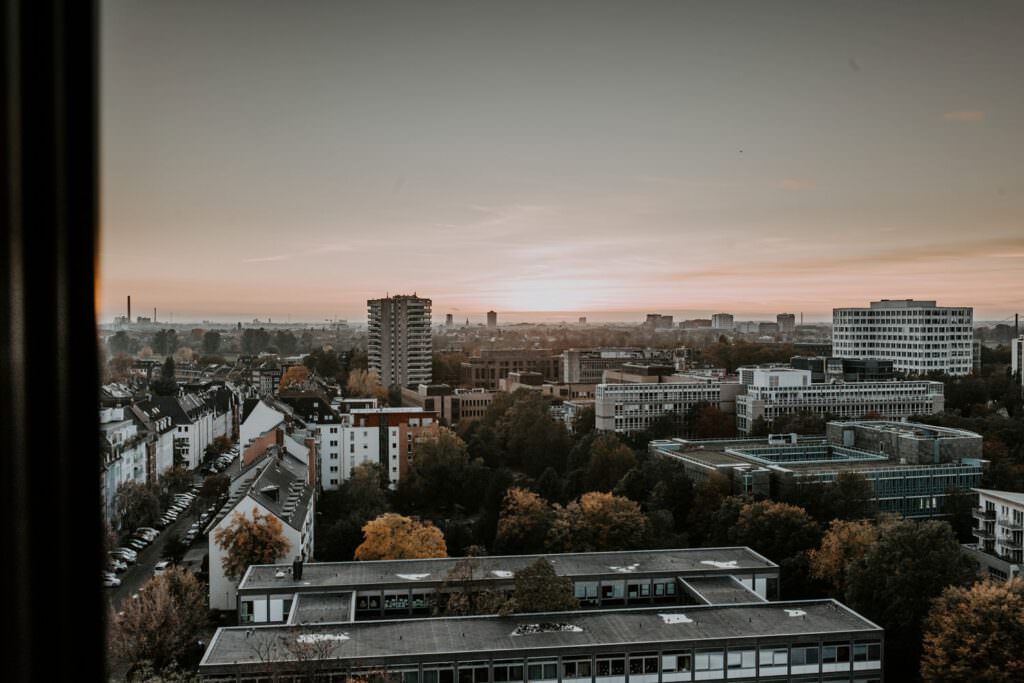 Blick über die Stadt Düsseldorf bis zum Horizont in den Sonnenuntergang. Von der Terasse der Fourty Four Hochzeitslocation